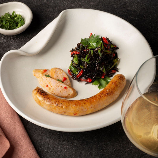 Dufour Gourmet Thai chicken sausage served with vegetables on a white plate